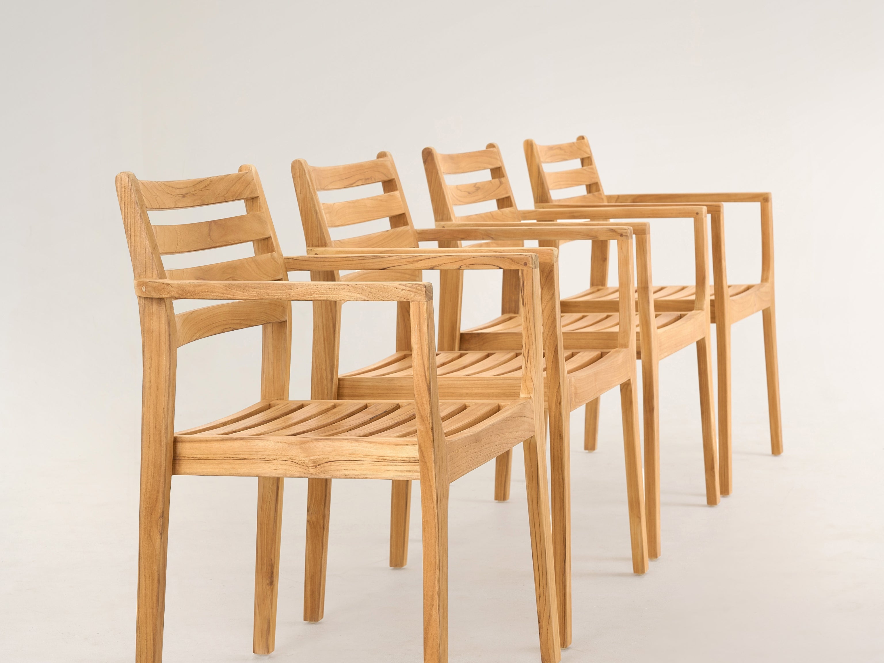Danois teak dining armchair with slatted back, angled view