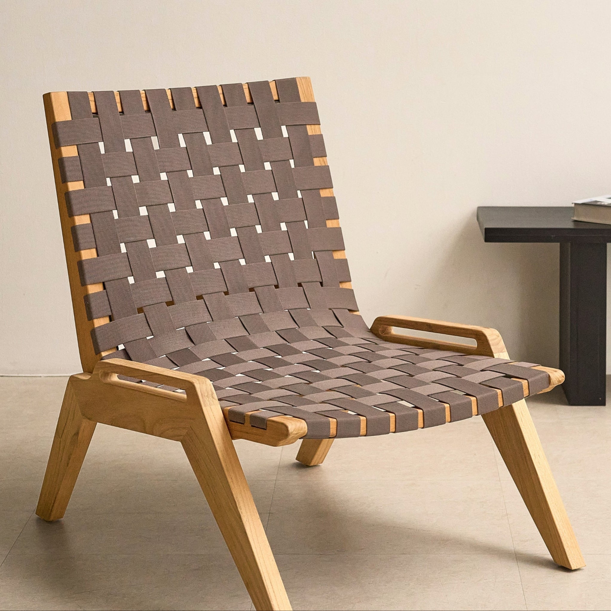 Laurent woven teak lounge chair, angled view